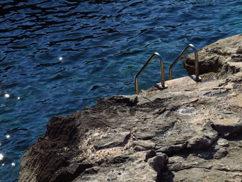 High angle view of a ladder in the rocks at sea shore