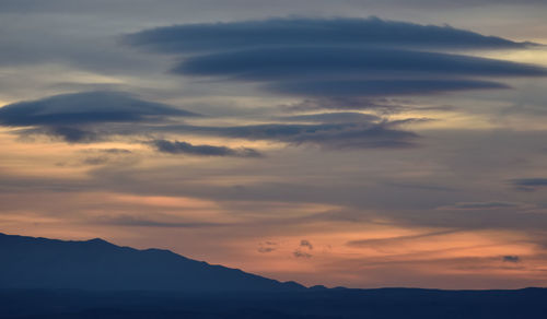 Scenic view of silhouette mountains against sky during sunset