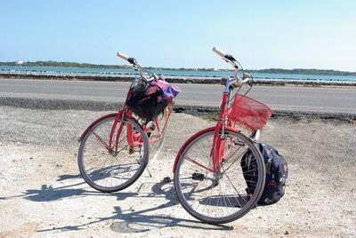 Bicycles on beach against clear sky