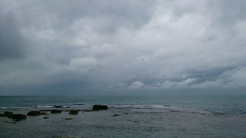 Scenic view of sea against cloudy sky