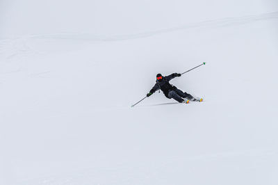 Low angle view of man skiing on snow