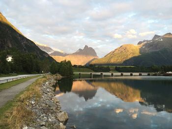 Scenic view of lake and mountains against sky