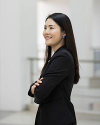 Side view of a smiling young woman