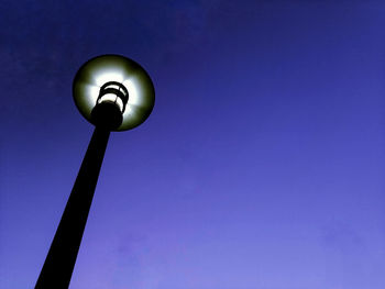 Low angle view of street light against blue sky