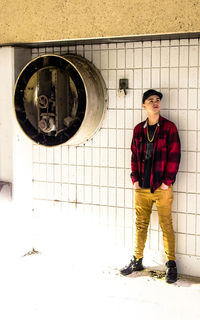 Portrait of a young man standing in corridor