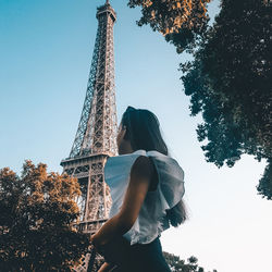 Low angle view of woman tower against sky