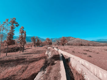 Panoramic view of road against clear blue sky