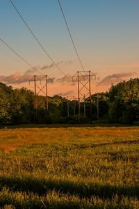 Scenic view of field against sky at sunset