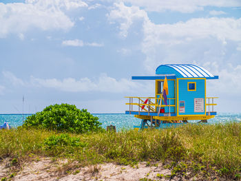 Lifeguard hut on beach against sky