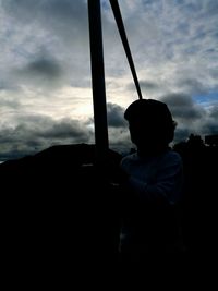 Silhouette boy against sky