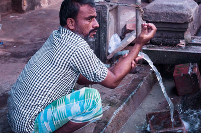 Side view of a man working in water