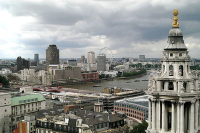 View of cityscape against cloudy sky