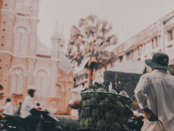 Rear view of vendor selling fruits