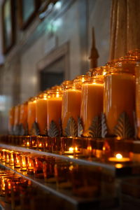 Illuminated tea light candles in church 