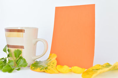 Close-up of coffee cup on table against white background