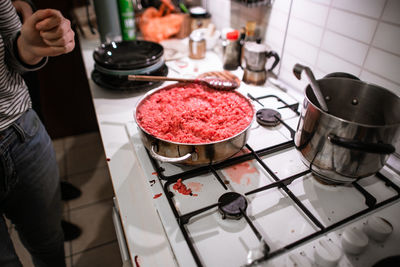 Midsection of man preparing food in kitchen at home