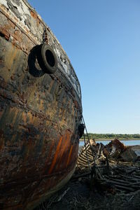 Abandoned boat against clear sky