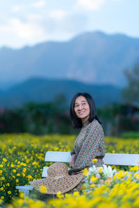 Portrait of a smiling young woman on field