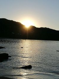 Scenic view of silhouette mountain against clear sky during sunset