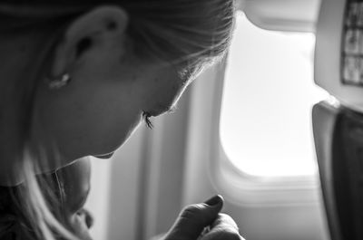 Close-up of mother with daughter sitting at airplane