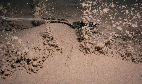 High angle view of wet sand on beach