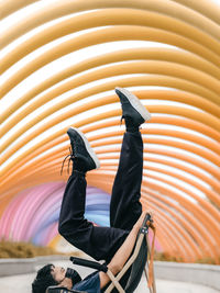 Low angle view of woman standing against wall