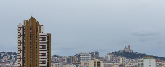 Buildings in city against sky