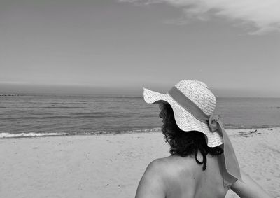 Rear view of woman looking at sea against sky