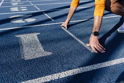 Sportsman at starting line of running track