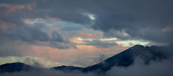 Low angle view of snowcapped mountains against sky during sunset