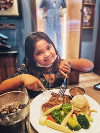 Portrait of young girl enjoying her food