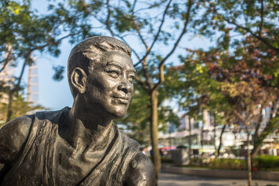 Low angle view of statue against trees