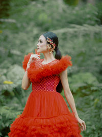 Portrait of young woman standing outdoors