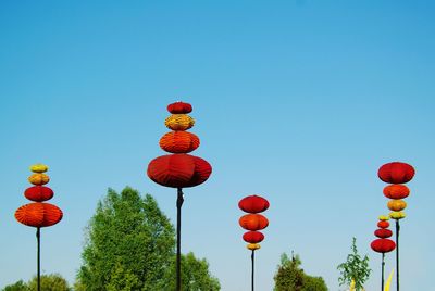 Low angle view of lanterns against clear sky