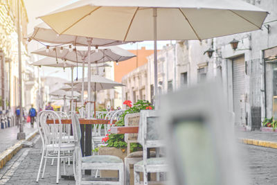 Outdoor cafe on cobblestone street, picturesque street with traditional houses and cafe tables