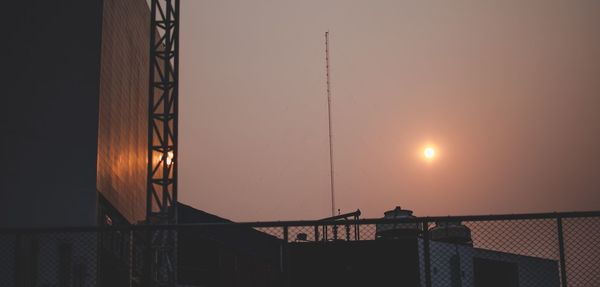 Low angle view of silhouette buildings against sky during sunset