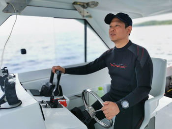 Side view of me sitting in the boat driving to a dive site destination