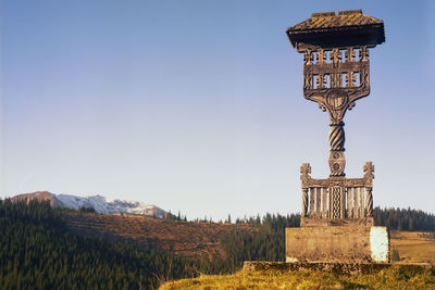 Totem on field against clear sky