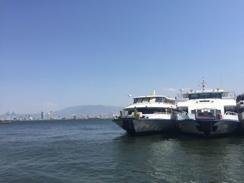 Ship in sea against clear blue sky