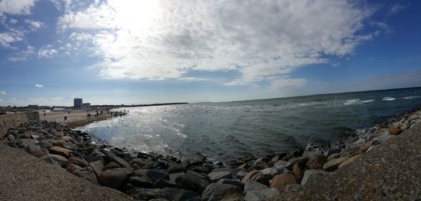 Scenic view of sea against cloudy sky