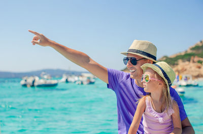 Side view of woman looking at sea against clear sky