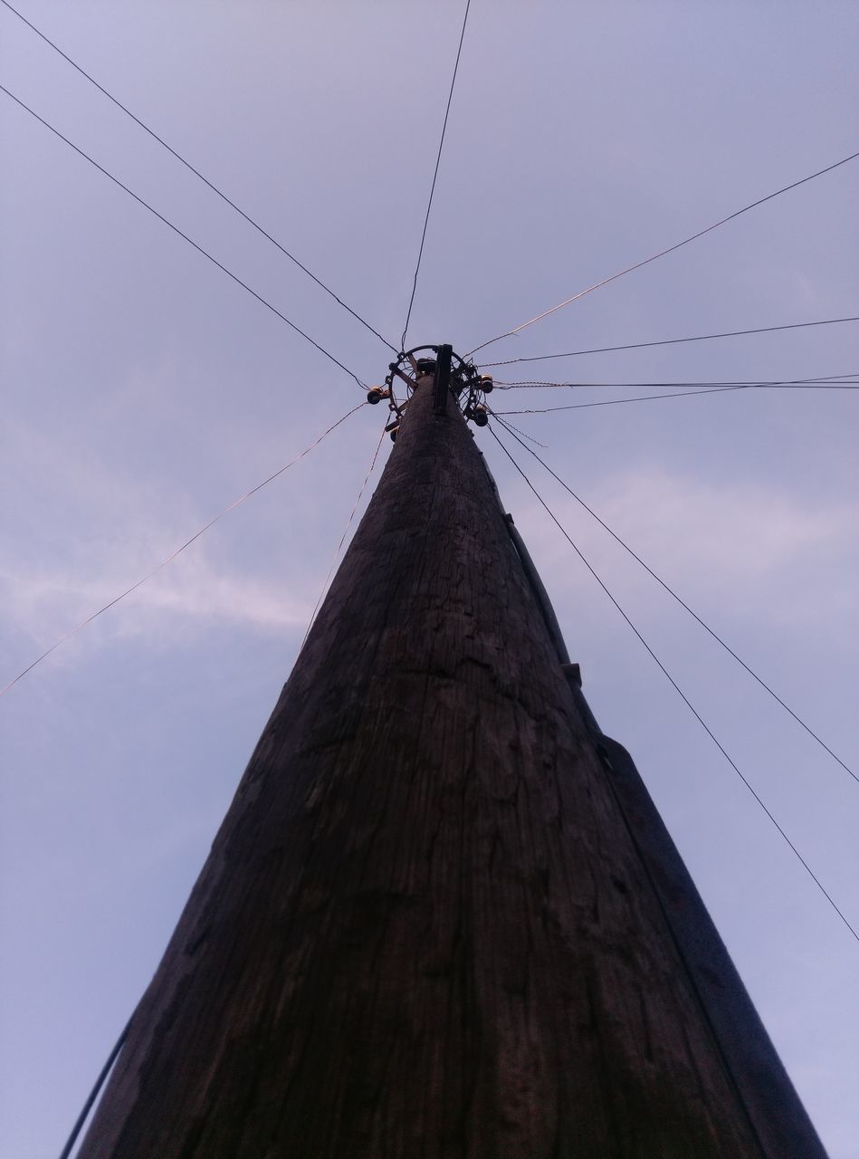 low angle view, bird, animal themes, animals in the wild, sky, flying, wildlife, perching, silhouette, clear sky, cable, power line, connection, built structure, outdoors, nature, day, flock of birds, no people