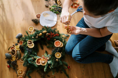 High angle view of mother and daughter preparing food on table