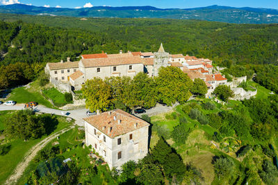 Scenic view of village and houses on mountain