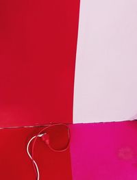 High angle view of pink paint on table against wall