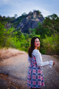 Young woman standing on road