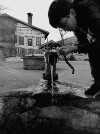 Reflection of boy and fountain in water