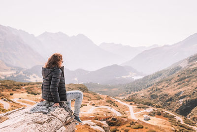 Man looking at mountain range against sky