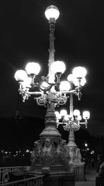 Low angle view of illuminated statue against sky at night