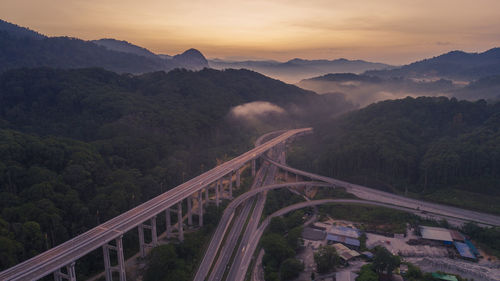 High angle view of bridge over mountains against sky